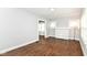 Bright living room with wood floors and a white brick fireplace, offering a welcoming space with ample natural light at 736 N Dequincy St, Indianapolis, IN 46201