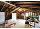 Unfinished attic space with exposed wood beams offers potential for custom renovation and added storage at 7425 E Thompson Rd, Indianapolis, IN 46239