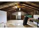 Unfinished attic space with exposed wood beams offers potential for custom renovation and added storage at 7425 E Thompson Rd, Indianapolis, IN 46239
