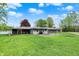 Backyard of this home featuring lush lawn, patio seating area, grill, and fire pit at 7425 E Thompson Rd, Indianapolis, IN 46239