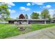 View of the backyard from the road highlighting its large lot and outdoor features at 7425 E Thompson Rd, Indianapolis, IN 46239