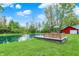 Backyard view of the pond and deck area, with a red barn structure in the background at 7425 E Thompson Rd, Indianapolis, IN 46239