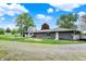 The back of the home showing a large lot, patio, ample parking, and room to enjoy at 7425 E Thompson Rd, Indianapolis, IN 46239