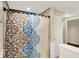 Stylish bathroom showcasing a colorful shower curtain and neutral tile at 7425 E Thompson Rd, Indianapolis, IN 46239