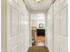 Bathroom entrance featuring sliding doors, leading to bathtub, vanity and mirror at 7425 E Thompson Rd, Indianapolis, IN 46239