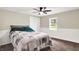 Cozy bedroom with a ceiling fan, comfortable queen bed, and bright natural light at 7425 E Thompson Rd, Indianapolis, IN 46239