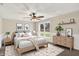 Comfortable bedroom with a ceiling fan, natural light, and stylish decor at 7425 E Thompson Rd, Indianapolis, IN 46239