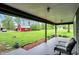 Comfortable seating area on the covered patio overlooks the expansive backyard and outbuildings at 7425 E Thompson Rd, Indianapolis, IN 46239