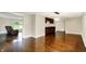 Spacious dining area with hardwood floors, built-in cabinets, and seamless flow into the living room at 7425 E Thompson Rd, Indianapolis, IN 46239