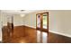 Large dining room with hardwood floors, modern lighting, and glass doors to the outdoor space at 7425 E Thompson Rd, Indianapolis, IN 46239