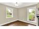 Light and bright dining room area has hardwood floors and two large windows at 7425 E Thompson Rd, Indianapolis, IN 46239
