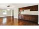 Open-concept dining room features hardwood floors and built-in cabinetry for elegant entertaining at 7425 E Thompson Rd, Indianapolis, IN 46239