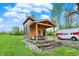 Charming wooden cabin with front porch featuring comfortable seating and a well-maintained lawn at 7425 E Thompson Rd, Indianapolis, IN 46239