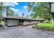 Welcoming home with a two-car garage, charming landscaping, and inviting walkway at 7425 E Thompson Rd, Indianapolis, IN 46239