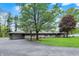 Charming home with mature landscaping and a driveway leading to an attached garage at 7425 E Thompson Rd, Indianapolis, IN 46239