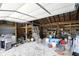 Large garage with gravel flooring and an overhead door for easy access to vehicles and storage at 7425 E Thompson Rd, Indianapolis, IN 46239