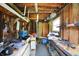 Workbench with cabinets in an unfinished garage features natural light from window and ample room for storage at 7425 E Thompson Rd, Indianapolis, IN 46239