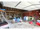 Spacious garage with overhead door and ample storage space; perfect for DIY projects or car enthusiasts at 7425 E Thompson Rd, Indianapolis, IN 46239