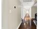 Long hallway features hardwood floors, neutral walls, and recessed lighting at 7425 E Thompson Rd, Indianapolis, IN 46239