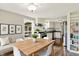 Inviting kitchen and dining area with white cabinets, stainless steel appliances, and natural light at 7425 E Thompson Rd, Indianapolis, IN 46239