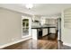 Bright kitchen features stainless steel appliances, white cabinetry, and wood flooring at 7425 E Thompson Rd, Indianapolis, IN 46239