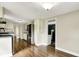 Spacious kitchen featuring white cabinetry, stainless steel appliances, and wood flooring at 7425 E Thompson Rd, Indianapolis, IN 46239