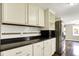 This kitchen features white cabinets, stainless steel appliances, and granite countertops at 7425 E Thompson Rd, Indianapolis, IN 46239