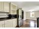 Bright kitchen featuring stainless steel appliances and ample white cabinetry space at 7425 E Thompson Rd, Indianapolis, IN 46239