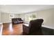 Inviting living room with hardwood floors, large windows, and comfortable seating arrangement at 7425 E Thompson Rd, Indianapolis, IN 46239