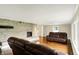 Bright living room features a stone fireplace, hardwood floors, and comfortable seating at 7425 E Thompson Rd, Indianapolis, IN 46239