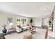 Bright and airy living room with hardwood floors, modern furniture, and large windows at 7425 E Thompson Rd, Indianapolis, IN 46239
