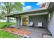 Covered porch with outdoor seating and charming landscaping at 7425 E Thompson Rd, Indianapolis, IN 46239