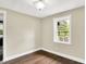 Neutral room featuring wood floors, white trim, and large windows with natural light at 7425 E Thompson Rd, Indianapolis, IN 46239