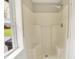 Clean shower with white surround and natural light from the window at 7425 E Thompson Rd, Indianapolis, IN 46239