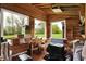Bright sunroom with natural wood finishes, large windows, and an inviting view of the surrounding landscape at 7425 E Thompson Rd, Indianapolis, IN 46239
