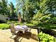 Inviting back deck with outdoor seating, perfect for enjoying the serene, tree-lined backyard at 7621 Forest Dr, Fishers, IN 46038