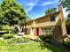 Spacious yard with a wooden deck featuring table and chairs, and brick and vinyl siding at 7621 Forest Dr, Fishers, IN 46038