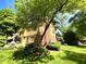 Back of home with brick and vinyl siding, a red door, and spacious yard at 7621 Forest Dr, Fishers, IN 46038