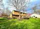 Expansive, lush backyard with a well-maintained lawn and mature trees surrounding the property, perfect for outdoor activities at 7621 Forest Dr, Fishers, IN 46038