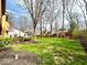View of the expansive, well-maintained lawn and mature trees of the backyard at 7621 Forest Dr, Fishers, IN 46038