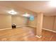 Spacious basement with hardwood floors, neutral walls, and a utility access at 7621 Forest Dr, Fishers, IN 46038