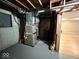 Unfinished basement featuring concrete walls, exposed wood beams, and utility access at 7621 Forest Dr, Fishers, IN 46038