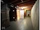 Unfinished basement featuring concrete walls, exposed wood beams, and utility access at 7621 Forest Dr, Fishers, IN 46038