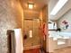 Bathroom featuring a glass shower, soaking tub, and unique wallpaper at 7621 Forest Dr, Fishers, IN 46038