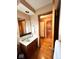 Bathroom with a wooden vanity, a mirror, and a doorway leading to other areas at 7621 Forest Dr, Fishers, IN 46038