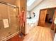 Bright bathroom featuring a glass shower, soaking tub, and stylish fixtures, with a door leading to another bedroom at 7621 Forest Dr, Fishers, IN 46038