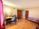 A charming bedroom featuring fun wall decals, wood flooring and a light blue desk at 7621 Forest Dr, Fishers, IN 46038