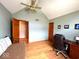 Bedroom featuring sloped ceilings, a futon couch and desk, with wooden floors and lots of natural light at 7621 Forest Dr, Fishers, IN 46038