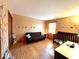 Charming bedroom featuring fun wall decals, wood flooring and a brown futon at 7621 Forest Dr, Fishers, IN 46038