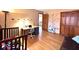 A bright bedroom featuring wall decals, wood flooring and a stylish desk at 7621 Forest Dr, Fishers, IN 46038